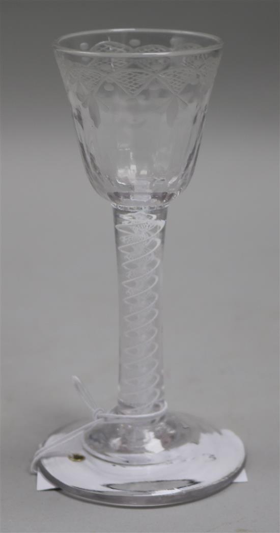 A cordial glass, c.1760, with fan cut fleur de lys engraved fluted bowl, multi-series opaque twist stem, 5.5in.